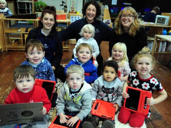 Principal Beki Shanahan (centre) and her team with children from the New Montessori Pre-school