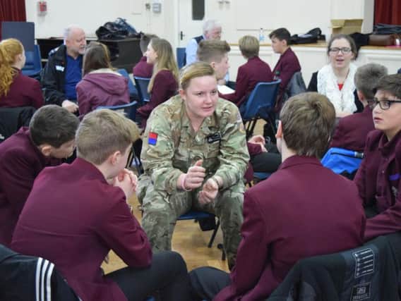 Students quiz one of their guests from the Armed Forces