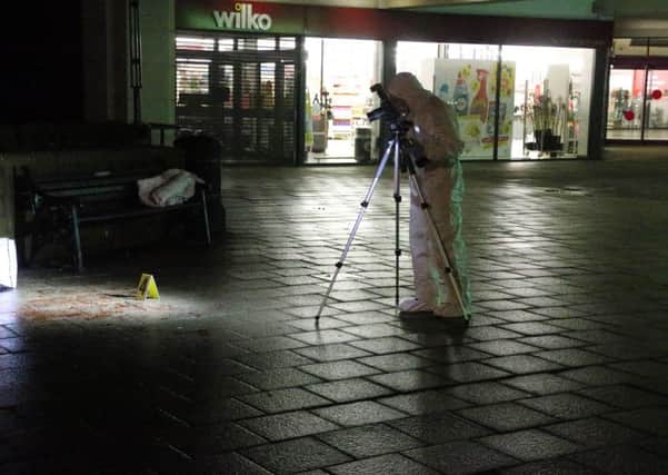 An expert examining the scene outside Wilko in Worthing. Pictures: Eddie Mitchell