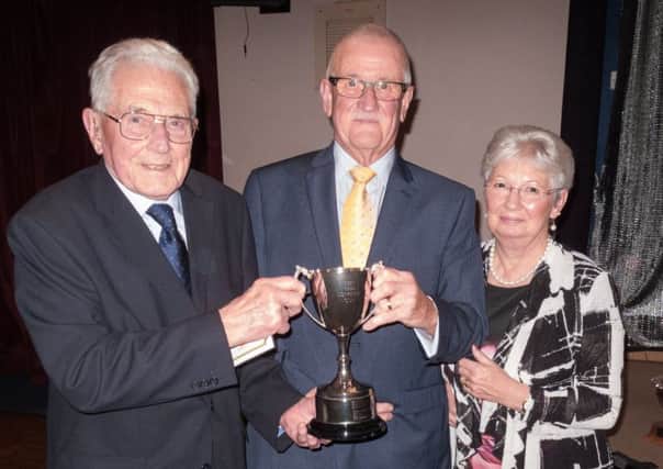 Oldest Southbourne member Len Mates receives the Longley Cup from Lindsay and Judy Bangs