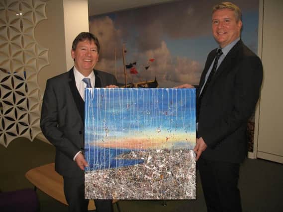 Paul Riley, right, and Stephen Hollamby  with a painting created by art student Isabel Collins