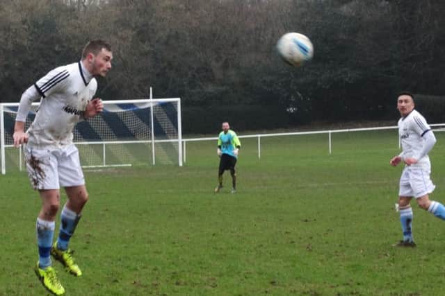 Bexhill United full-back Kenny Butchers wins a header as Ashley Kidman looks on. Picture courtesy Mark Killy