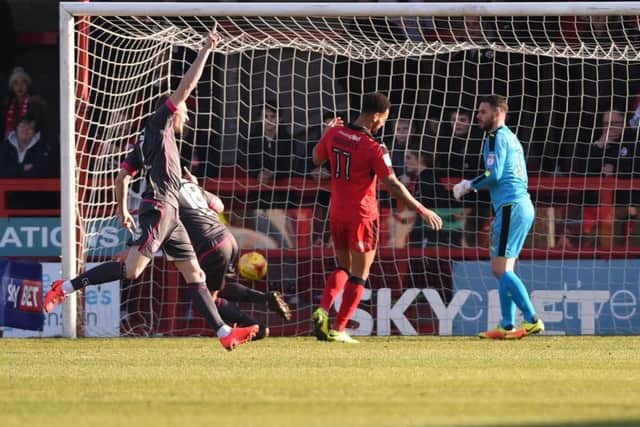 Paul Mullin scores Morecambe's second goal against Crawley Town. Jordan Roberts and Glenn Morris look on.
Picture by PW Sporting Photography