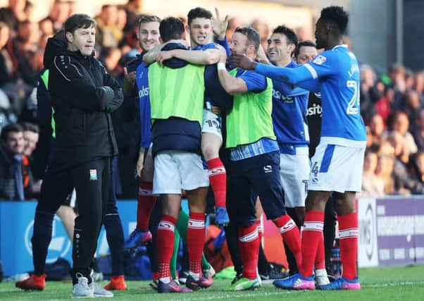 New Barnet boss Kevin Nugent, left, cuts a frustrated figure as Conor Chaplin celebrates his late Pompey leveller   Picture: Joe Pepler
