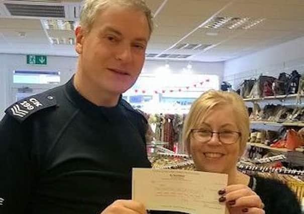 Sergeant Simon Kind with Age UK shop manager Lyn. Picture: Sussex Police