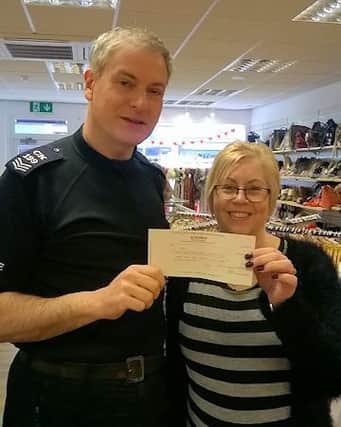 Sergeant Simon Kind with Age UK shop manager Lyn. SUS-170221-111209001