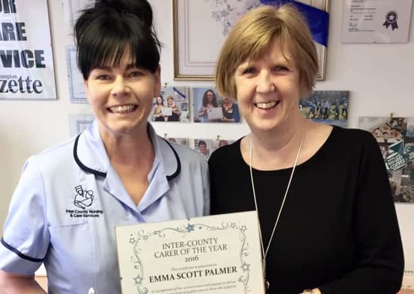 Emma Scott-Palmer receives her Carer of the Year award from her manager, Gill Wicks