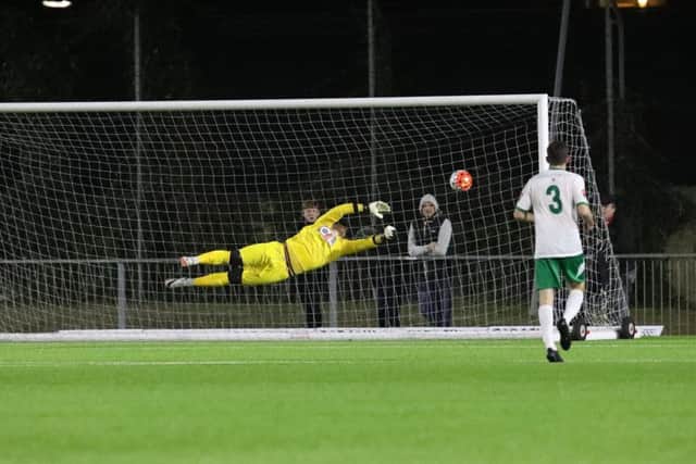 Dan Lincoln at full stretch to save a Crawley shot in their win over the Rocks / Picture by Tim Hale