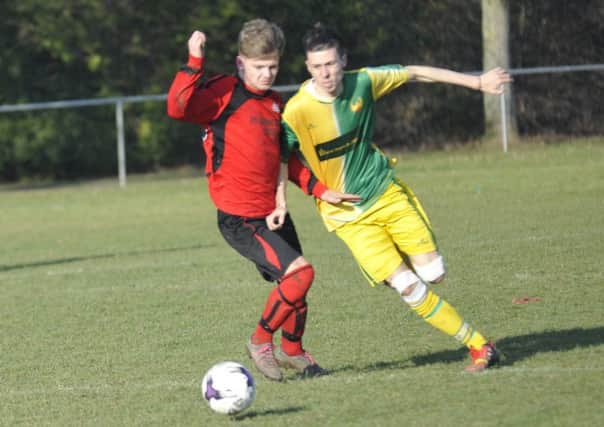 Rye Town midfielder Sammy Foulkes tussles with Westfield's Curtis Coombes. Picture by Simon Newstead