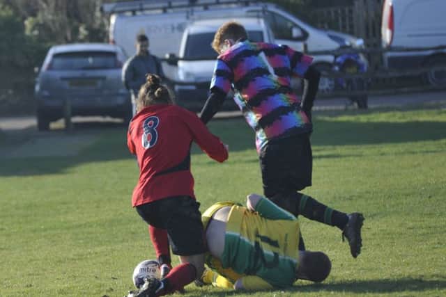 Ben Heffernan tussles for the ball with the Westfield goalkeeper and a defender.