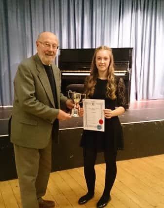 Ken Johnson, a vice president of Hastings Music Festival, presents the Ken Johnson Cup for Verse and song 14-16yrs to Finity Soan SUS-170103-084307001