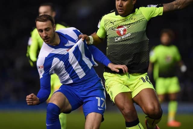 Reading's Liam Moore gets to grips with Glenn Murray in this evening's Championship clash at the Amex. Picture by PW Sporting Photography