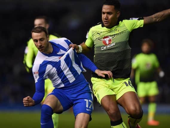 Reading's Liam Moore gets to grips with Glenn Murray in this evening's Championship clash at the Amex. Picture by PW Sporting Pics