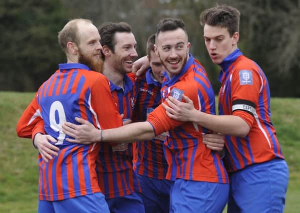 Battle celebrate after taking an early lead against Cleanslate. Pictures by Simon Newstead