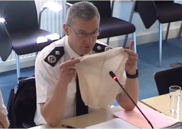 Deputy chief constable Bernie O'Reilly holding up the type of spit hood used by Sussex Police. Picture: Sussex PCC