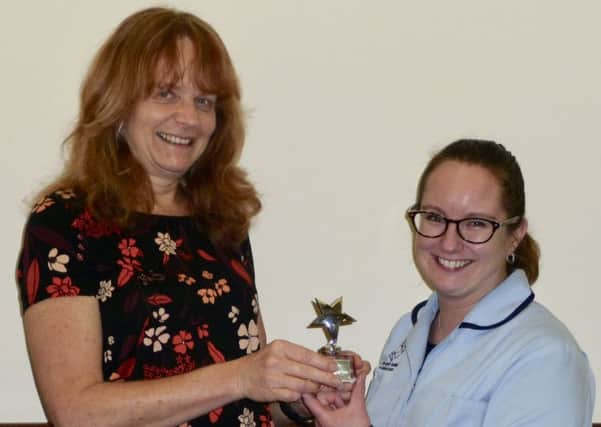 Registered manager Susan Brigstock presents the Carer of the Year award to Nikki Scott