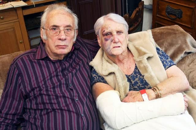 Mary Tolhurst broke her elbow after tripping on a road cover outside Nationwide in North Road, Lancing. She is pictured with husband John, who tripped at the same spot the day before. Picture: Derek Martin