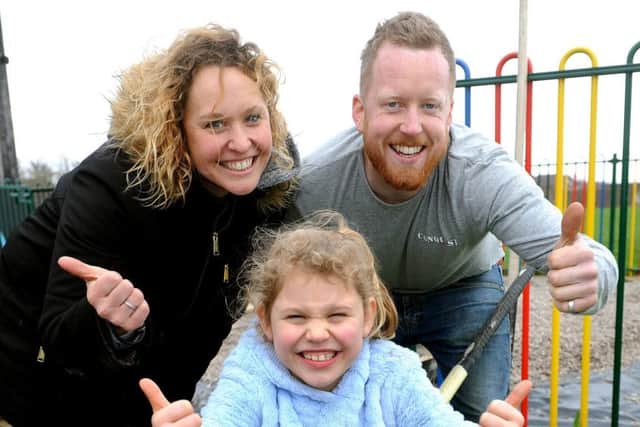 Holly Armstrong with her daughter Olivia and Ross Conquest. Picture: Steve Robards