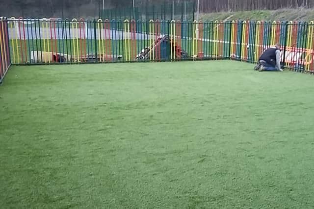 After shot of the pre-school's play area with Ross making some finishing touches