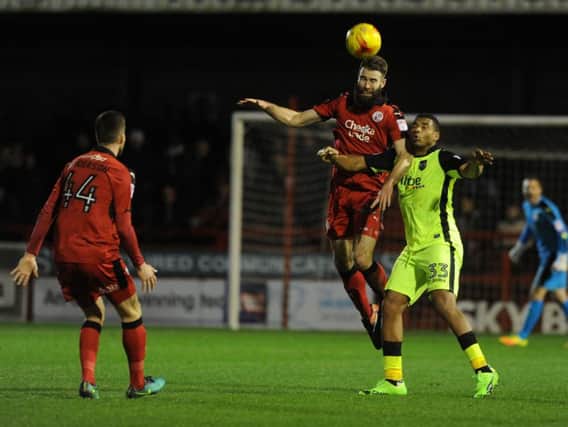 Joe McNerney goes up for a header against Exeter. 
Picture by Jon Rigby
