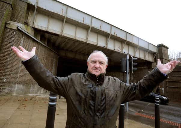 Tony Power, 72, pictured by the railway bridge outside Haywards Heath railway station. Picture: Steve Robards