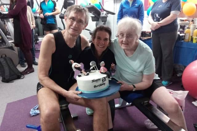 Organiser Julie Taylor presents Tom with a special rowing birthday cake