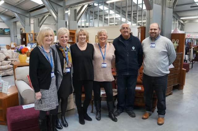 Staff celebrate the grand opening of the new furniture outlet