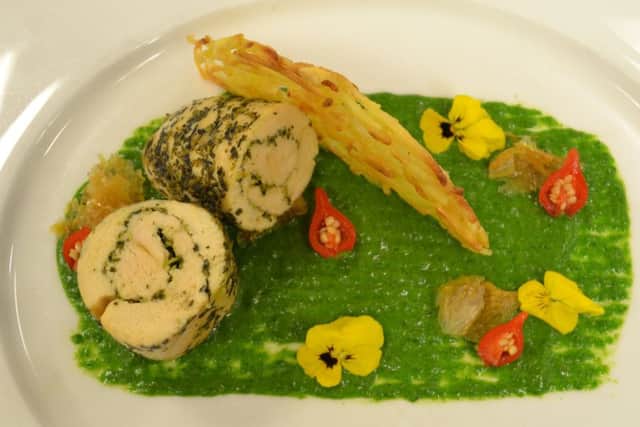 Chicken and herb roulade on spinach and coconut puree with a spicy jus