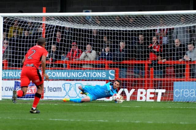 Crawley Town keeper Glenn Morris saves from the penalty spot to deny Doncaster's John Marquis. Picture by STEVE ROBARDS