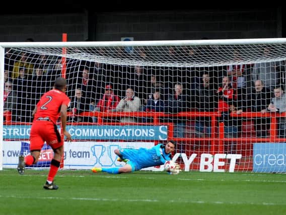 Crawley Town keeper Glenn Morris saves from the penalty spot to deny Doncaster's John Marquis. Picture by STEVE ROBARDS