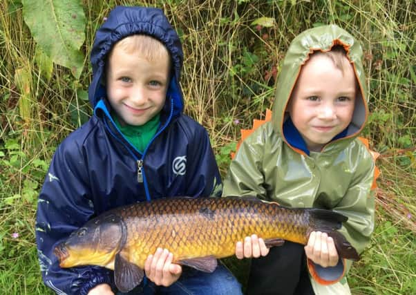 Ewan and Finley Hayes with a carp caught on one of Petworth and Bognor's waters