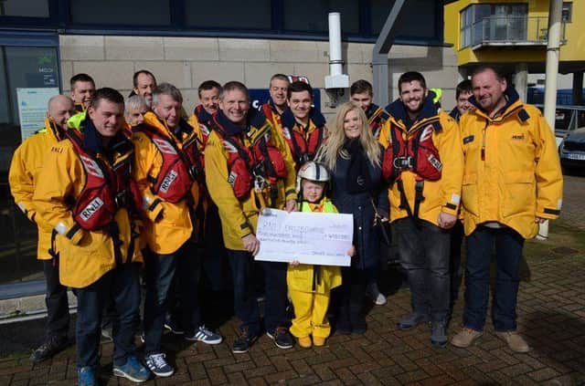 James Williams presenting a cheque to the RNLI SUS-170603-141947001