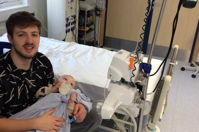 Dad Owen with his young son in hospital