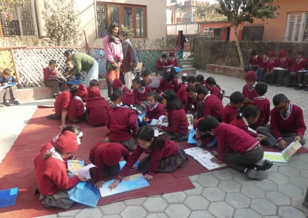 Children enjoying their books in an outdoor reading class. Picture: Tony Parris