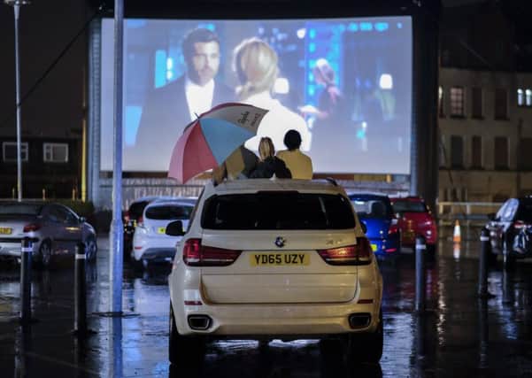 Customers enjoying Bridget Jones's Baby at drive-in cinema at Tesco Extra SUS-170703-130152001