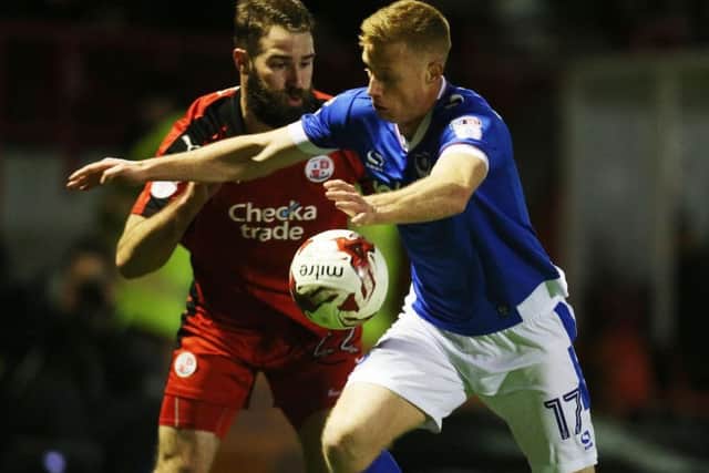 Crawley's Joe McNerney battles for the ball with Portsmouth's Eoin Doyle.
Picture by JOE PEPLER