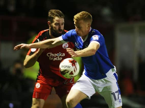 Crawley's Joe McNerney battles for the ball with Portsmouth's Eoin Doyle.
Picture by JOE PEPLER