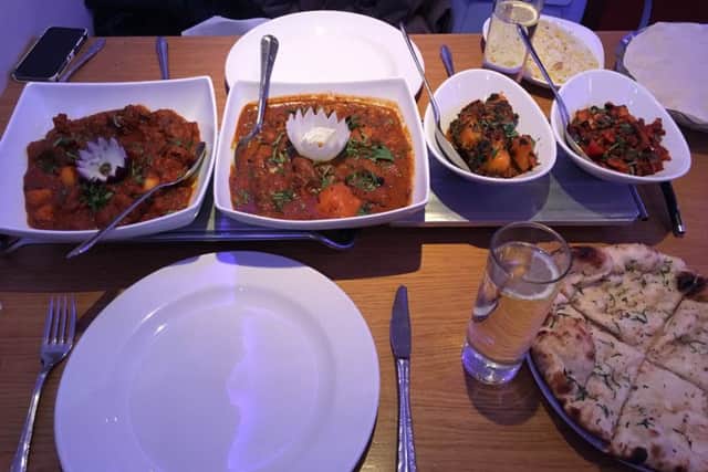 The achari and Bengali fish curries (left) were accompanied by Bombay potatoes, mushroom bhaji (right), pilau rice and garlic naan bread