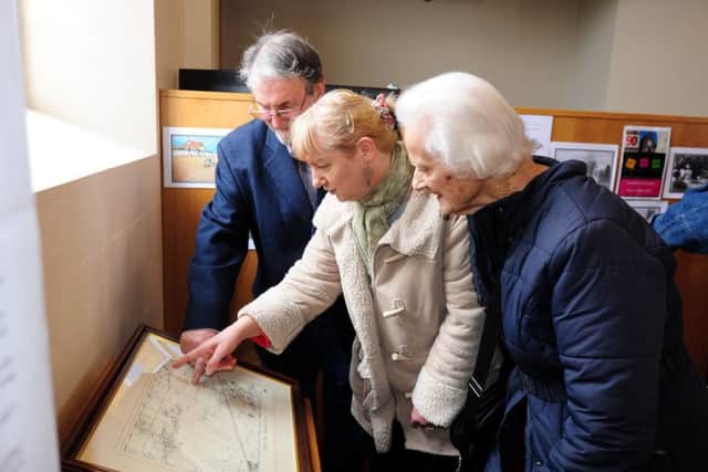 Exhibition organiser Haydn Tout, left, Betty Smith and Lesley Brett looking at the exhibition ks170135-2