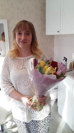 Vicky, the 100th client, received a bouquet from Sophisticated Hair