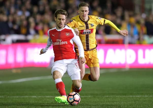Adam May in action for Sutton against Arsenal