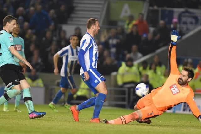 Glenn Murray finishes Brighton & Hove Albion's third goal past Scott Carson