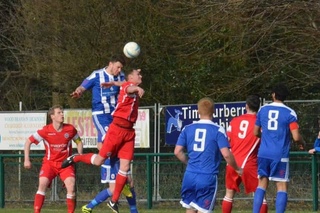 Nathan Cooper shows his strength in the air. Crawley Down Gatwick v Haywards Heath Town. Picture by Grahame Lehkyj