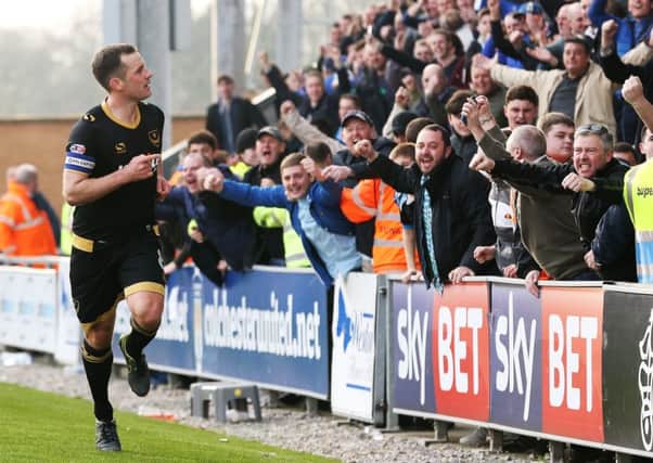 Michael Doyle celebrates his goal with the Pompey fans. Picture: Joe Pepler