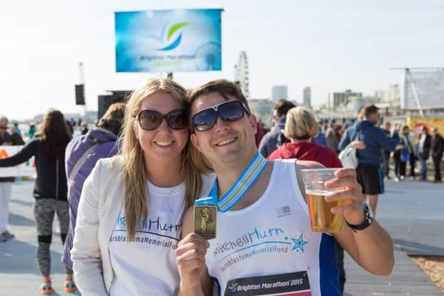 A finisher and supporter enjoying the 2016 Brighton Marathon Weekend Event Village (Photograph: Kevin Meredith) SUS-170313-101459001