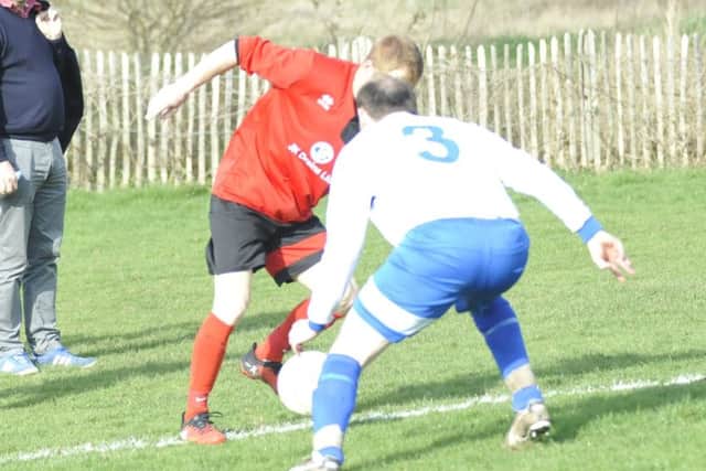 The Sedlescombe Rangers left-back blocks the path of a Bexhill AAC opponent.