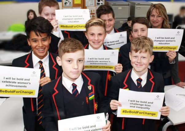 Year 8 students with #BeboldForChange selfie cards from the campaign SUS-170314-123634001