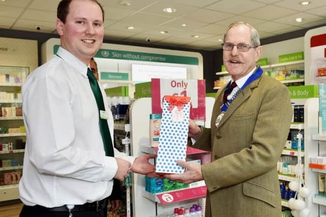 Parish council chairman Ray Osgood reopened the Lloyds Pharmacy in Henfield. Picture: Lloyds SUS-170314-152740001