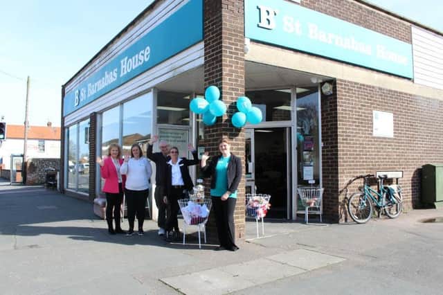 Staff and volunteer team outside the shop front