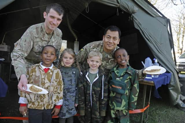 From left, Private Luke Ward and Cpl Santa Tamang with Brandon Khumalo (four), Lily Knight (five), Joseph Graham (five), and Jayden Horton (five) 170322-1